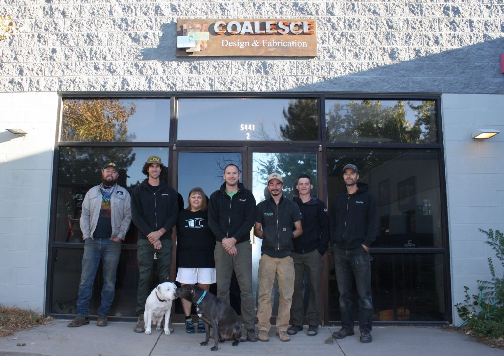 The Coalesce team and shop dogs standing in front of Coalesce customization workshop